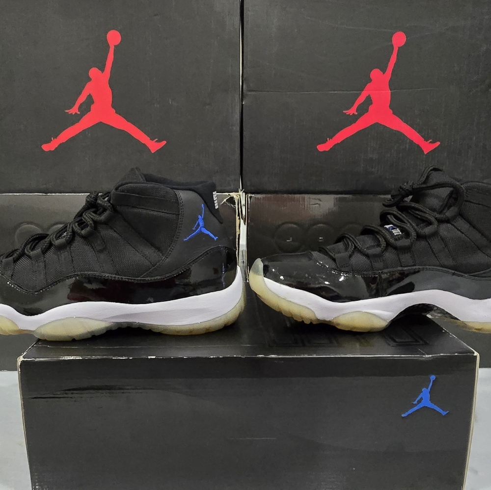 This is a pair of Air Jordan 11 Retro 'Space Jam' sneakers, featuring a black up
